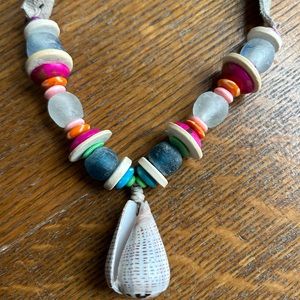 Multi colored Twine and Twig shell necklace with grey suede.